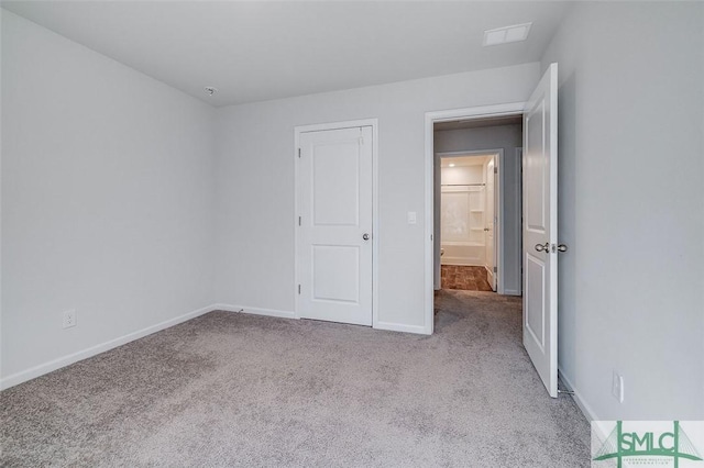 unfurnished bedroom featuring light carpet