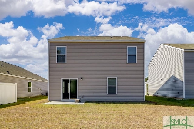 rear view of house featuring a patio area and a lawn