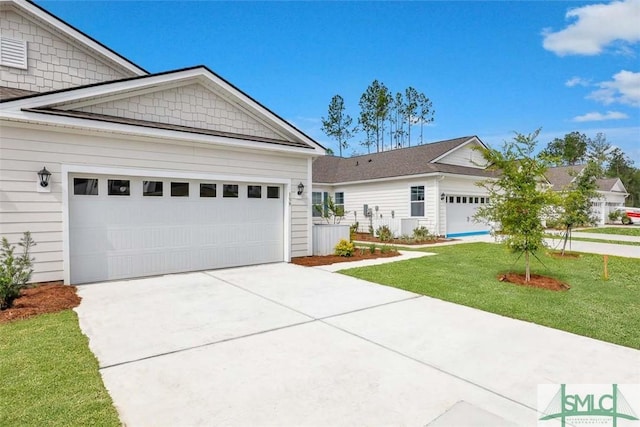 view of front facade with a garage and a front lawn