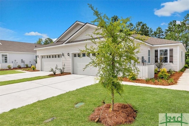 view of front of house with a garage and a front lawn