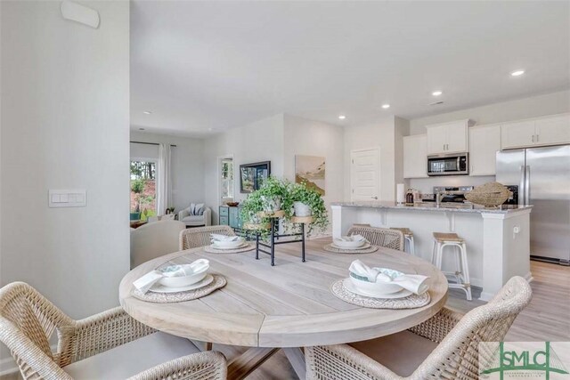 dining room with light hardwood / wood-style flooring