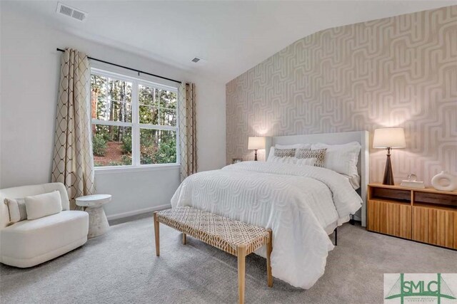 carpeted bedroom with lofted ceiling