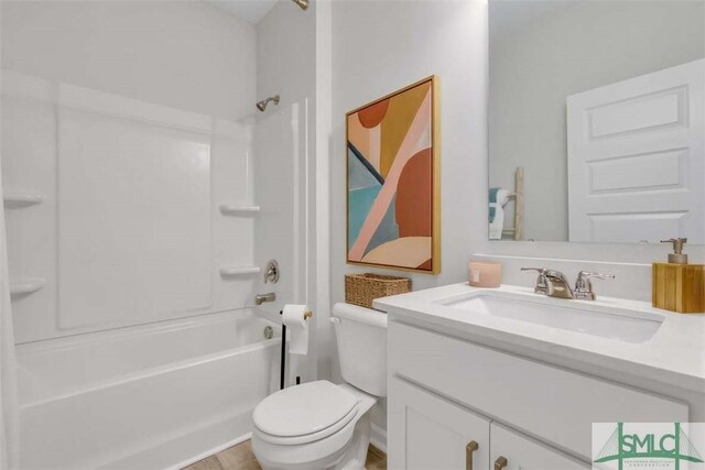 full bathroom featuring toilet, vanity, and washtub / shower combination