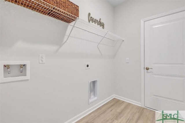 clothes washing area featuring washer hookup, wood-type flooring, and hookup for an electric dryer