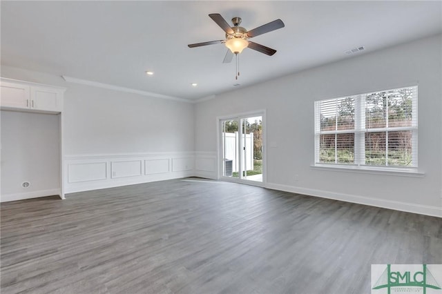 spare room featuring crown molding, ceiling fan, and dark wood-type flooring