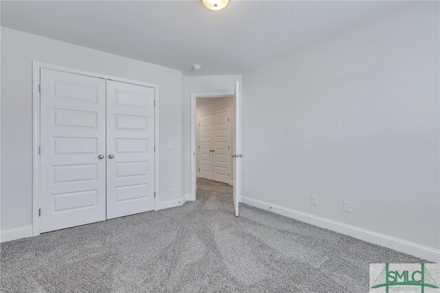 unfurnished bedroom featuring carpet and a closet