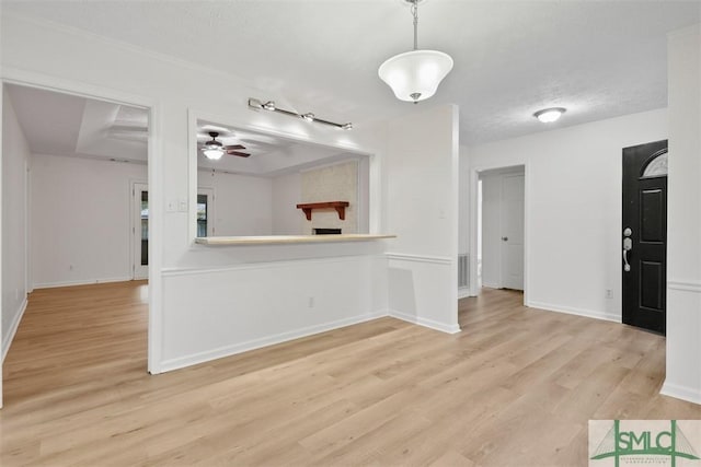 unfurnished room featuring ceiling fan, a textured ceiling, and light wood-type flooring