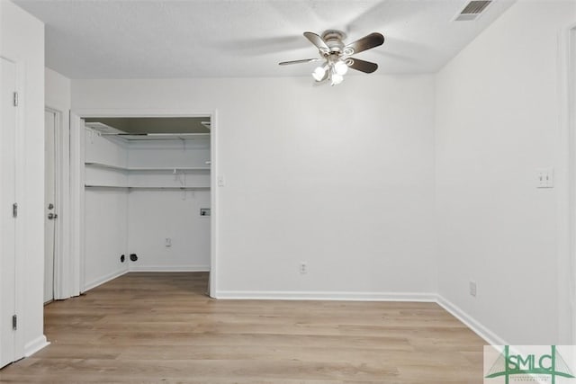 unfurnished bedroom with ceiling fan, light hardwood / wood-style floors, and a textured ceiling