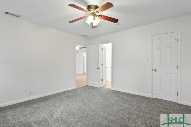 spare room featuring ceiling fan and carpet flooring