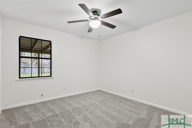 unfurnished room with ceiling fan and carpet