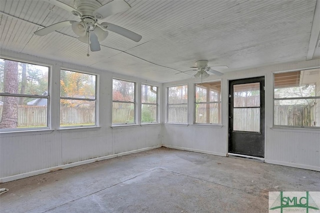 unfurnished sunroom with ceiling fan