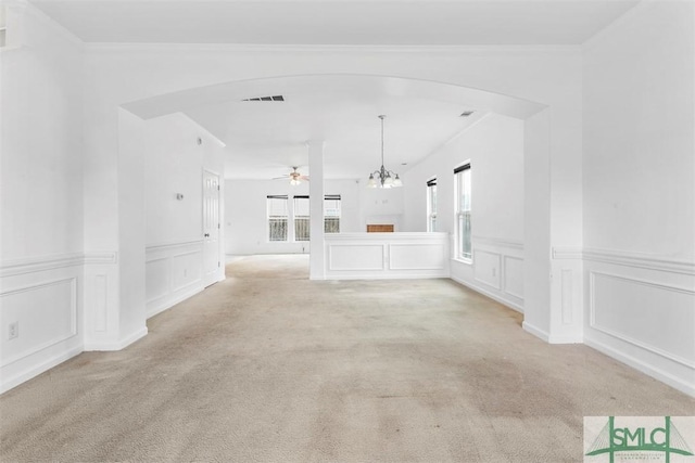 unfurnished living room featuring light colored carpet and ceiling fan with notable chandelier