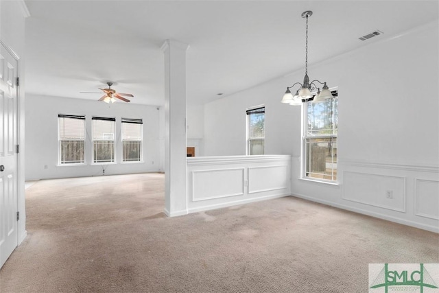 interior space with ceiling fan with notable chandelier