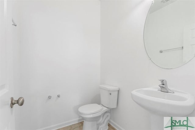 bathroom featuring sink and toilet