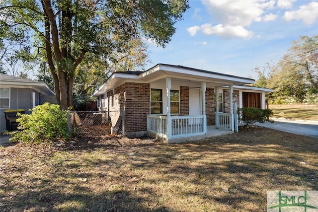 view of front of property with a porch and a front yard