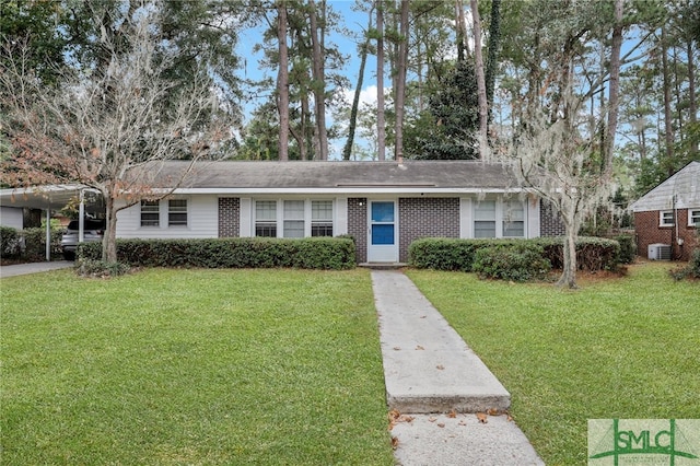 ranch-style house featuring cooling unit, a front yard, and a carport