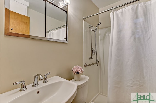 bathroom with curtained shower and sink