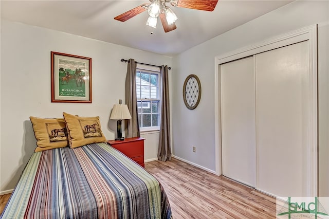 bedroom featuring ceiling fan, a closet, and light hardwood / wood-style flooring