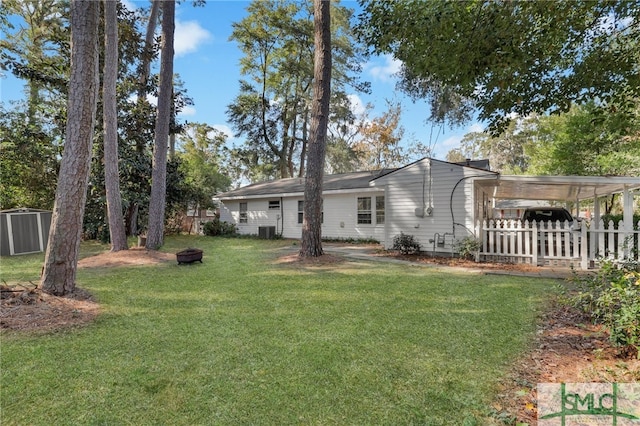 back of house with a lawn and a carport