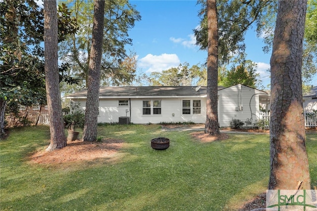 back of property featuring a lawn and central AC