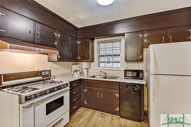 kitchen featuring black appliances, dark brown cabinets, sink, and light hardwood / wood-style flooring