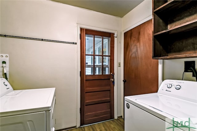 clothes washing area featuring washer and dryer and dark wood-type flooring