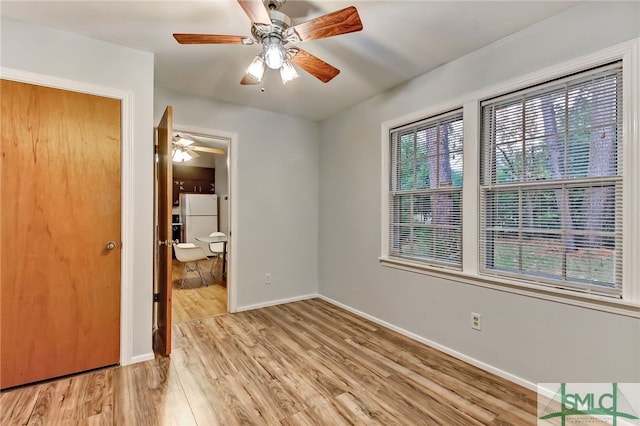 spare room with ceiling fan and light hardwood / wood-style flooring