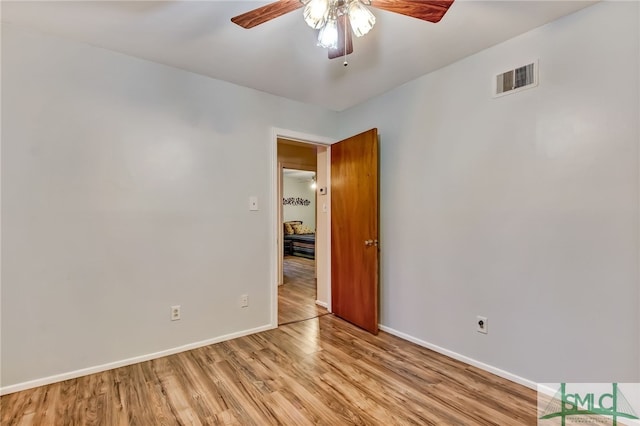 spare room featuring light hardwood / wood-style flooring and ceiling fan