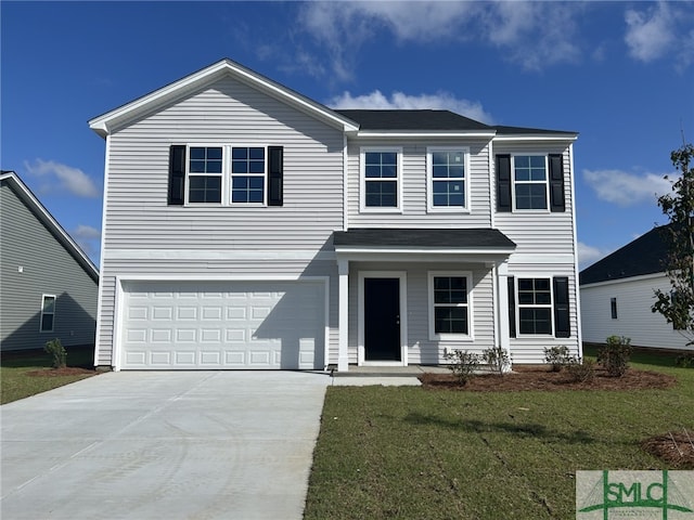 traditional home featuring an attached garage, driveway, and a front yard
