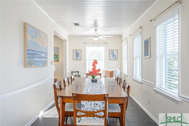 tiled dining space featuring plenty of natural light and ornamental molding