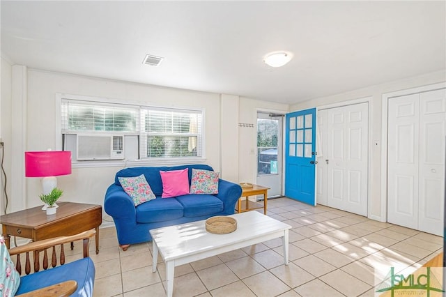 tiled living room with plenty of natural light and cooling unit