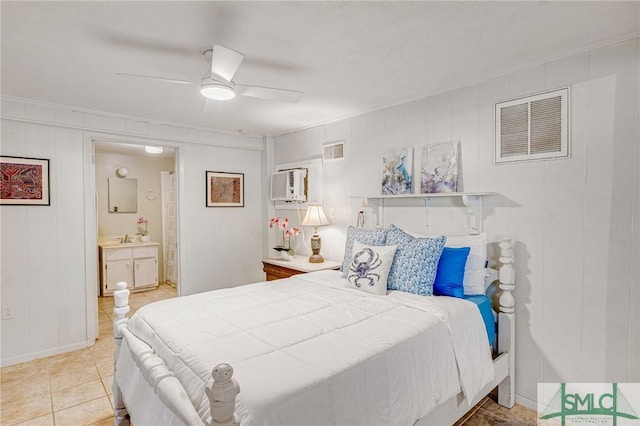 bedroom featuring ensuite bath, ceiling fan, sink, an AC wall unit, and tile patterned floors