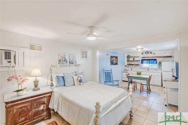 bedroom with ceiling fan, white refrigerator, and light tile patterned flooring