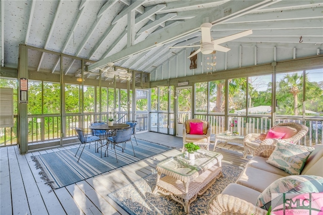 sunroom with ceiling fan and vaulted ceiling