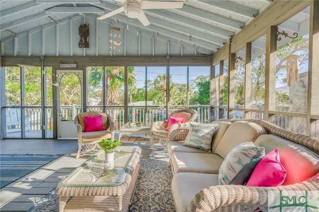 sunroom / solarium featuring lofted ceiling with beams, ceiling fan, and a healthy amount of sunlight