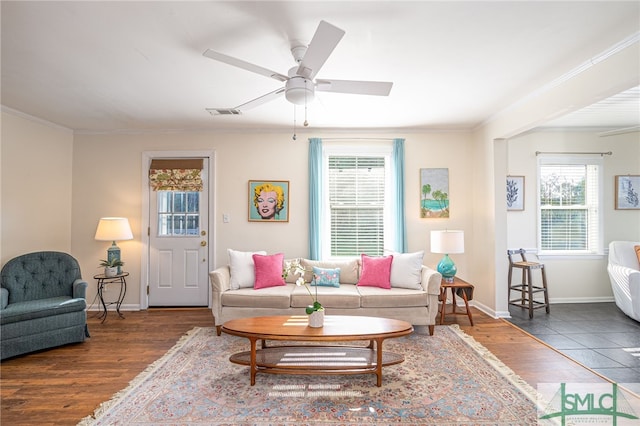 living room with dark hardwood / wood-style floors, ceiling fan, and crown molding