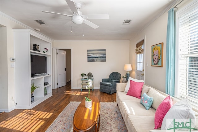 living room with ceiling fan, dark hardwood / wood-style flooring, built in features, and crown molding