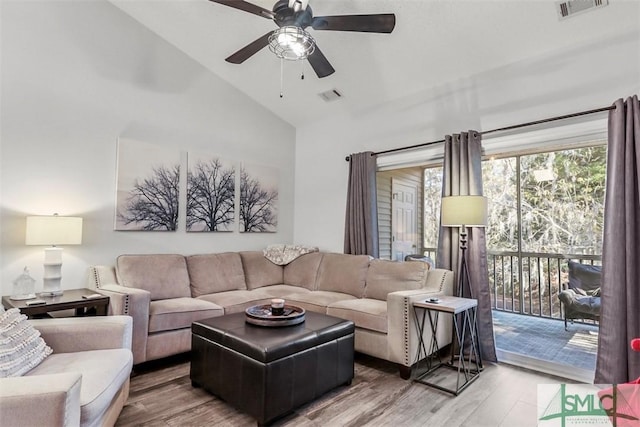 living room featuring wood-type flooring, high vaulted ceiling, and ceiling fan