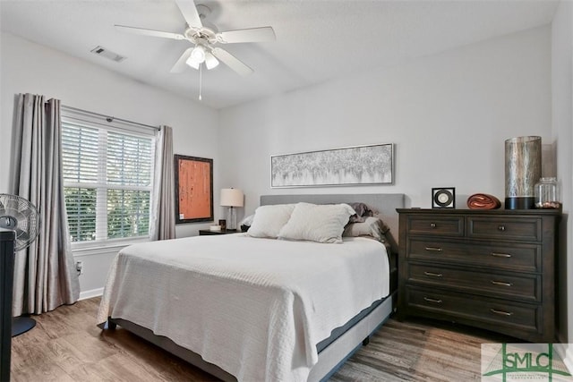 bedroom with hardwood / wood-style flooring and ceiling fan