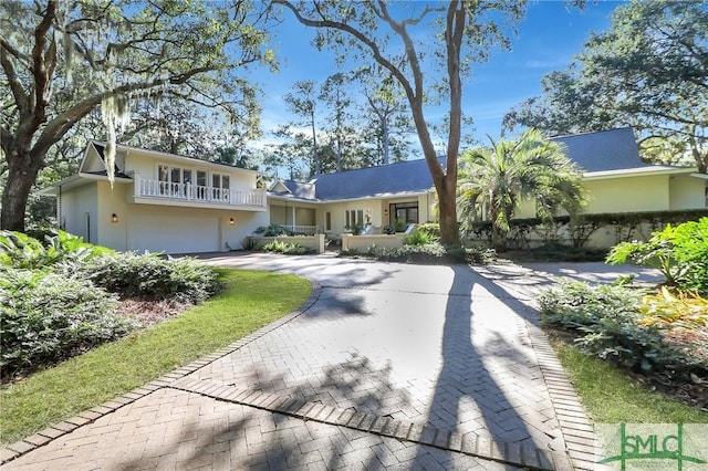 view of front of home featuring a garage and a balcony