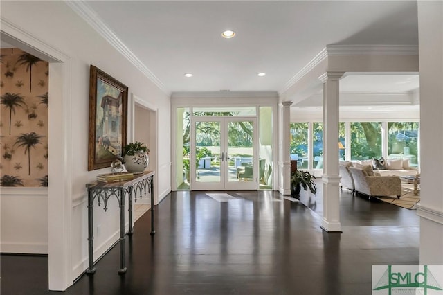 doorway featuring dark hardwood / wood-style flooring, crown molding, and french doors