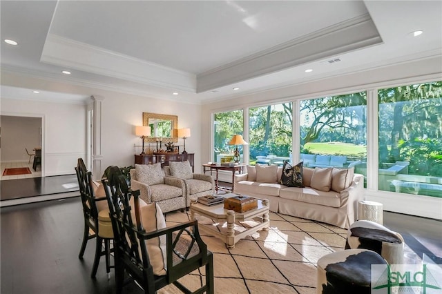 living room featuring a tray ceiling and crown molding