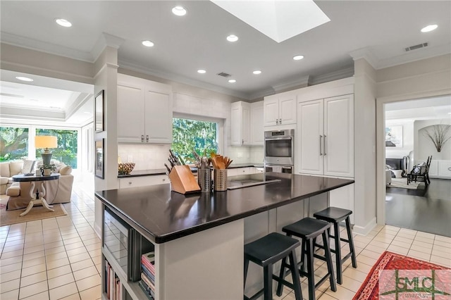 kitchen with white cabinetry, plenty of natural light, and light tile patterned floors