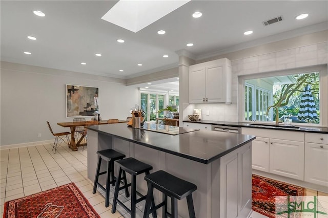 kitchen with white cabinetry, plenty of natural light, and sink