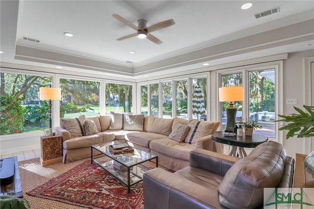 sunroom / solarium featuring ceiling fan