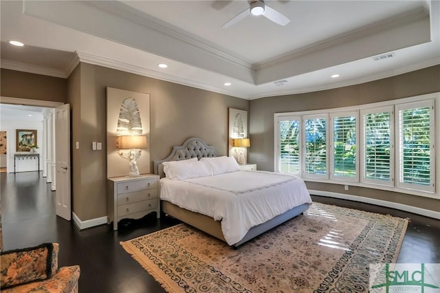 bedroom featuring ceiling fan, dark hardwood / wood-style floors, a raised ceiling, and crown molding