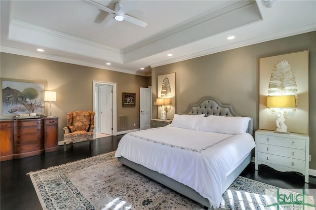 bedroom featuring dark hardwood / wood-style flooring, a tray ceiling, ceiling fan, and crown molding