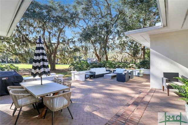 view of patio featuring outdoor lounge area and a grill