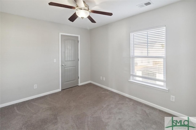 carpeted spare room featuring ceiling fan