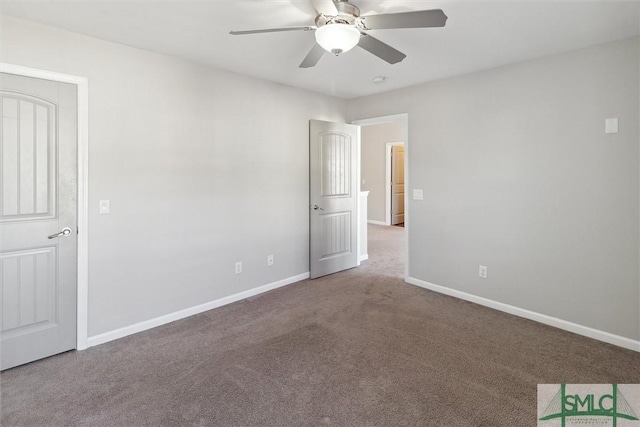 carpeted spare room with ceiling fan